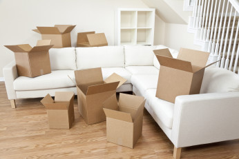 Empty room full of cardboard boxes for moving into a new home.